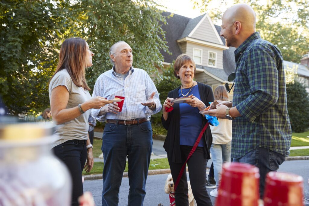 Happy neighbors talking about their new roof