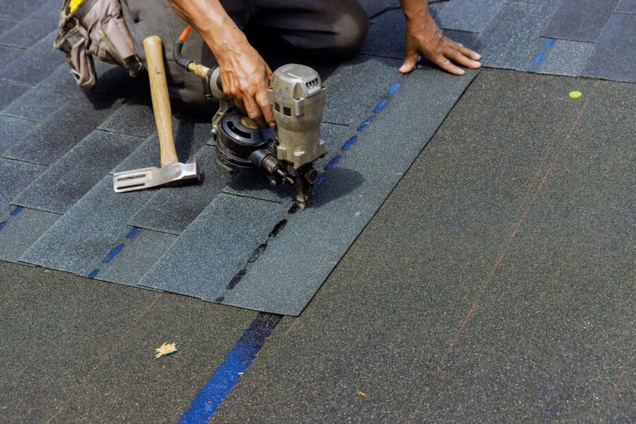 Asphalt shingles being added to a felt roof underlayment